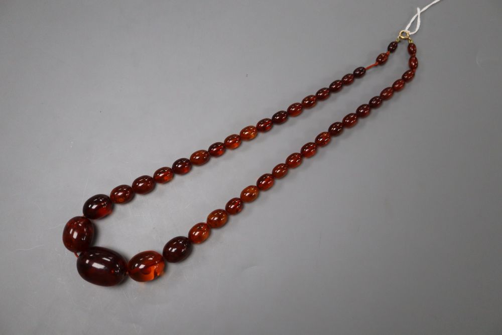 A single strand graduated oval amber bead necklace, 55cm, gross 45 grams.